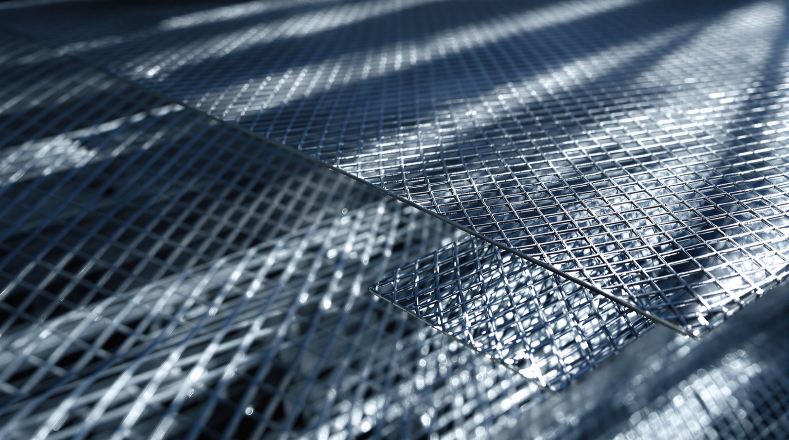 Stacked expanded metal sheets showing the diamond mesh pattern